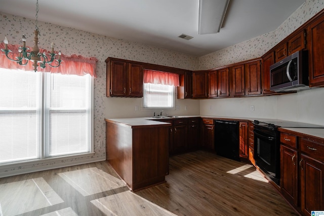 kitchen featuring dark hardwood / wood-style floors, sink, and black appliances