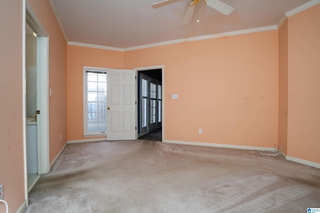 carpeted empty room with ceiling fan and ornamental molding