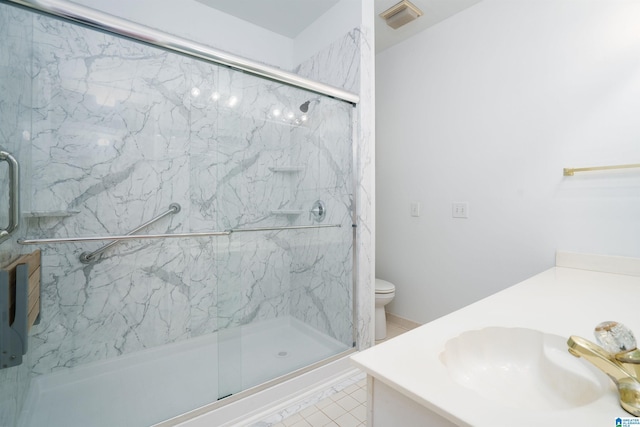 bathroom with vanity, an enclosed shower, tile patterned floors, and toilet