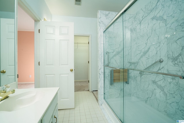 bathroom with vanity, tile patterned flooring, and walk in shower