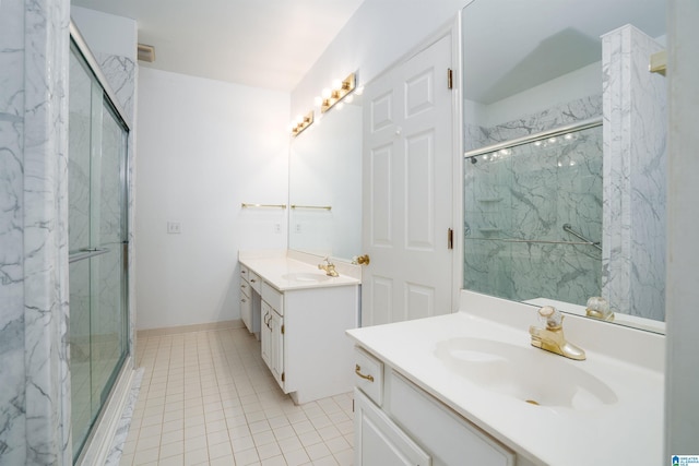 bathroom featuring vanity, tile patterned flooring, and a shower with door