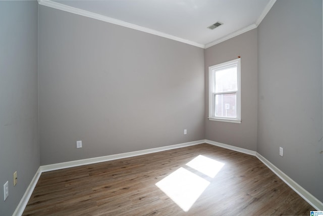 unfurnished room featuring wood-type flooring and ornamental molding