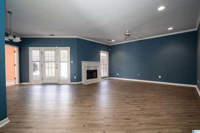 unfurnished living room with ornamental molding, a healthy amount of sunlight, and a fireplace