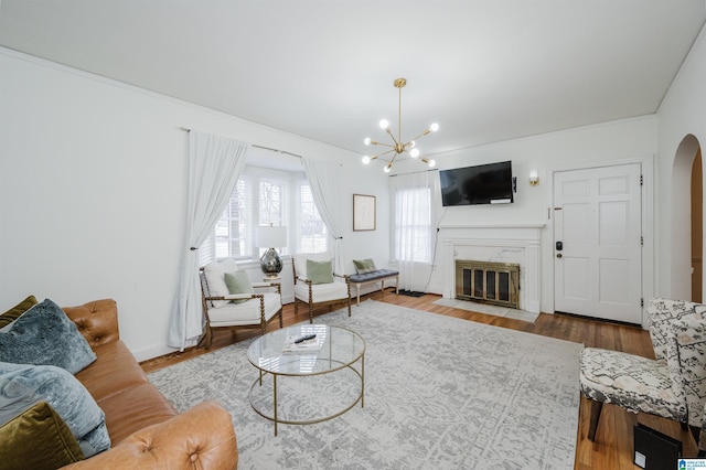 living room featuring hardwood / wood-style flooring and an inviting chandelier