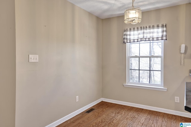 unfurnished dining area featuring hardwood / wood-style floors