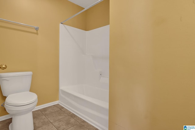 bathroom with toilet and tile patterned flooring