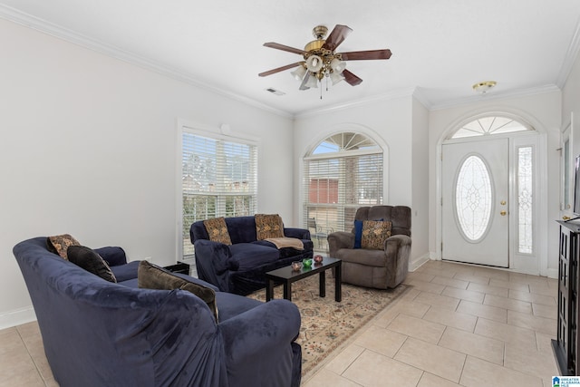 living room featuring crown molding, ceiling fan, light tile patterned floors, and a wealth of natural light