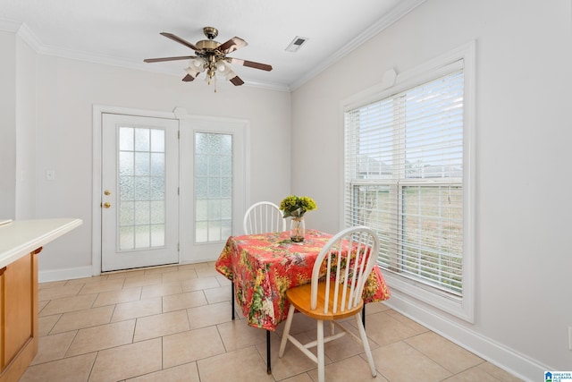 dining space featuring plenty of natural light, ornamental molding, and light tile patterned flooring