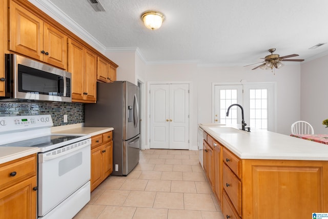 kitchen featuring sink, tasteful backsplash, ornamental molding, an island with sink, and stainless steel appliances