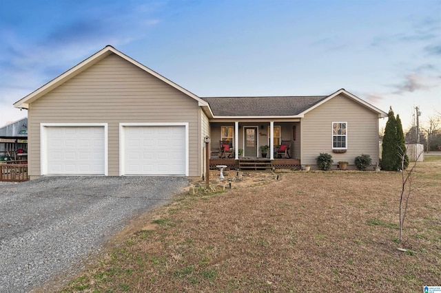 ranch-style house with a porch and a garage