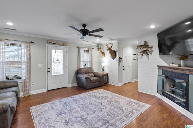 living room with hardwood / wood-style flooring, plenty of natural light, and ornamental molding