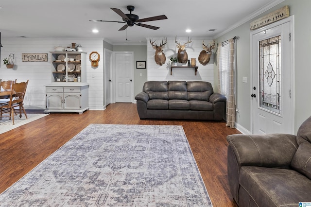 living room with crown molding, ceiling fan, and dark hardwood / wood-style flooring