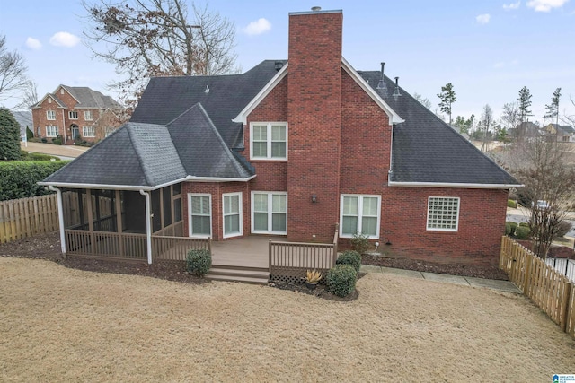 back of house with a wooden deck and a sunroom