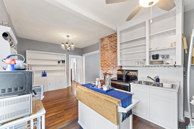 kitchen with sink, stainless steel range with electric stovetop, hanging light fixtures, dark hardwood / wood-style floors, and white cabinets