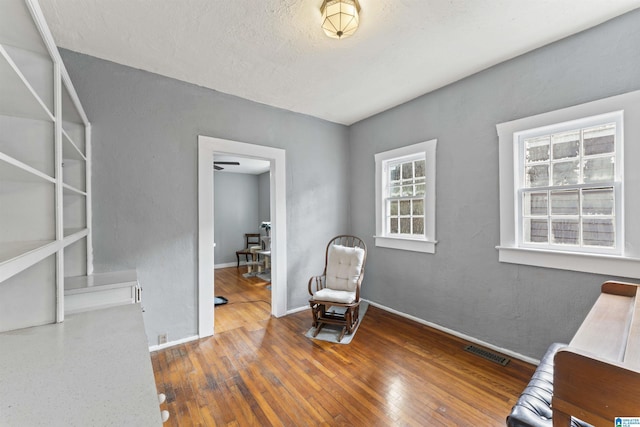 sitting room with wood-type flooring