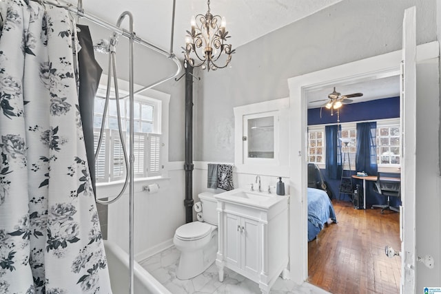 bathroom with vanity, ceiling fan, a shower with curtain, and toilet