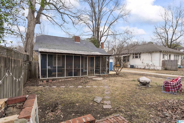 back of property with a sunroom