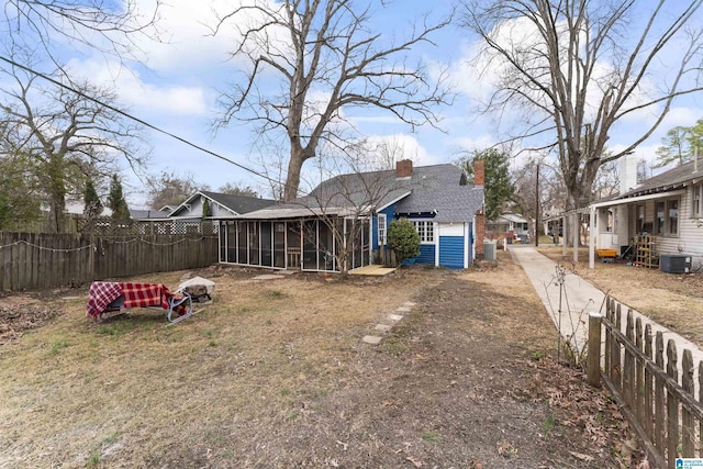 view of yard featuring a sunroom and central air condition unit