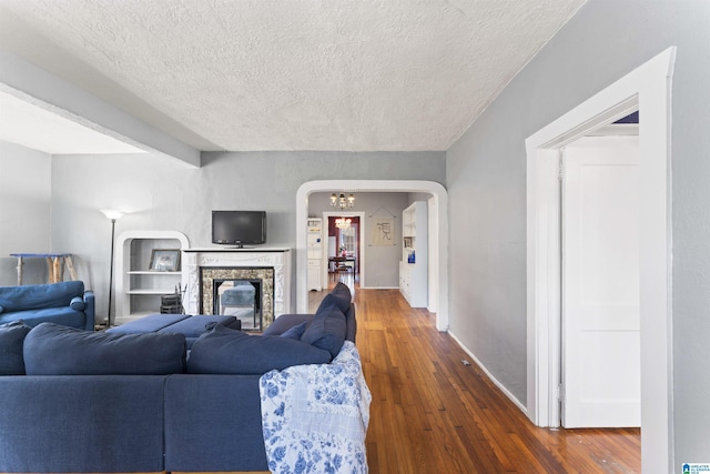 living room featuring a textured ceiling and dark hardwood / wood-style flooring