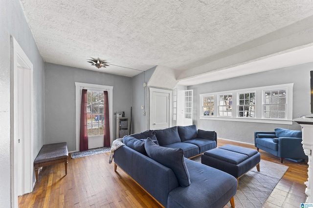 living room with hardwood / wood-style flooring and a textured ceiling