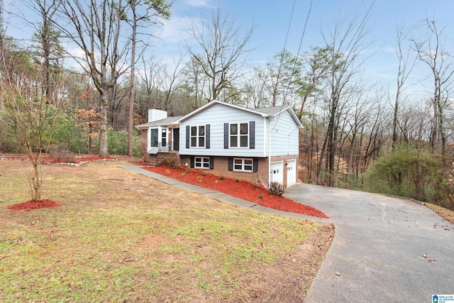 view of front of home with a garage and a front lawn