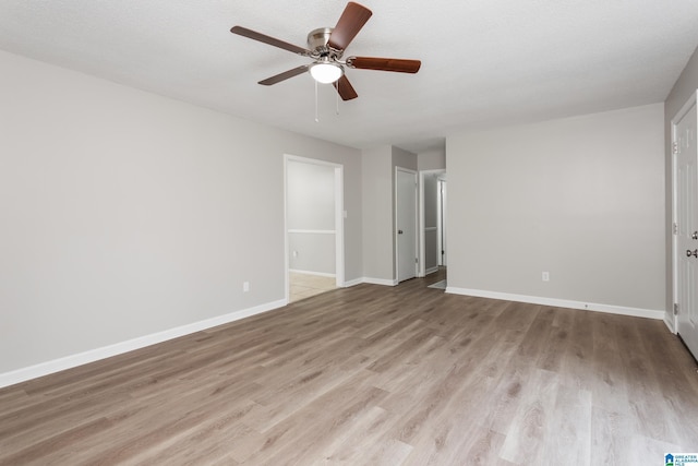 unfurnished bedroom with ensuite bath, a textured ceiling, ceiling fan, and light wood-type flooring