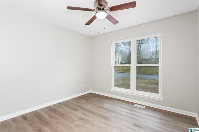 empty room featuring ceiling fan and light wood-type flooring