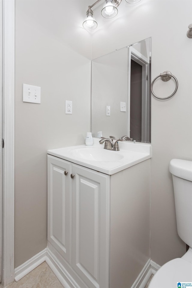 bathroom featuring vanity, tile patterned floors, and toilet