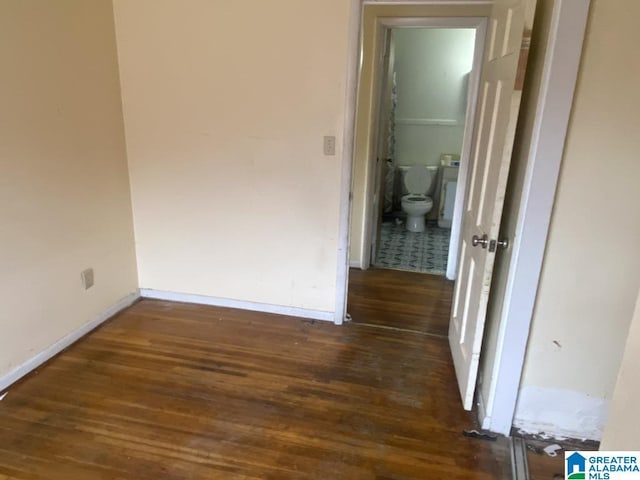 hallway with dark hardwood / wood-style floors