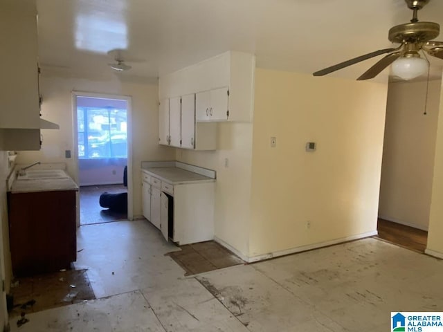 kitchen with sink, white cabinets, and ceiling fan