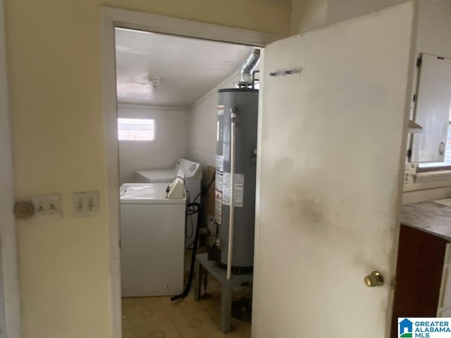 clothes washing area featuring water heater, ornamental molding, and separate washer and dryer