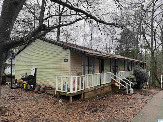 rear view of property with a porch