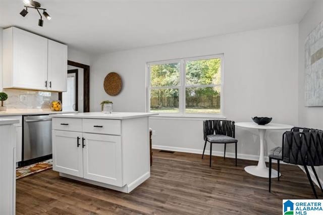 kitchen featuring white cabinetry, decorative backsplash, stainless steel dishwasher, and dark hardwood / wood-style floors