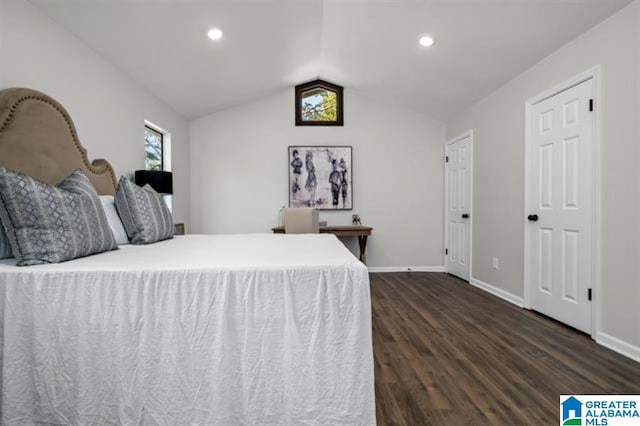 unfurnished bedroom with vaulted ceiling and dark hardwood / wood-style flooring