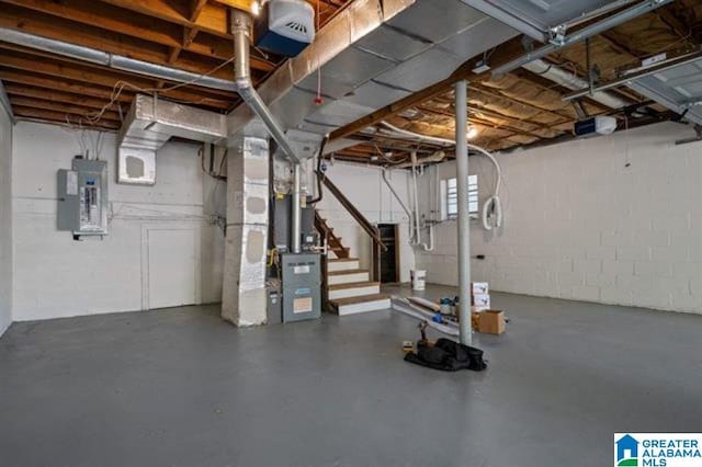 basement featuring heating unit and electric panel