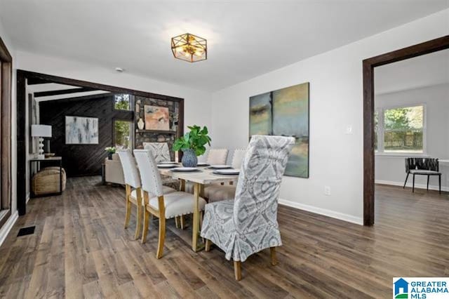 dining area with dark hardwood / wood-style floors