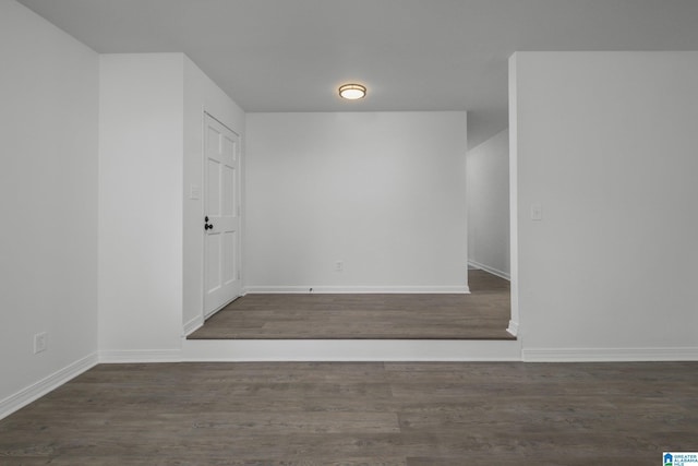 empty room featuring dark wood-type flooring