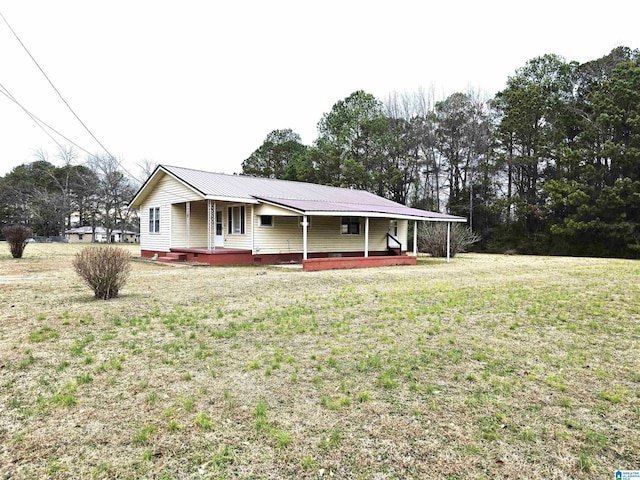 ranch-style house with covered porch and a front lawn