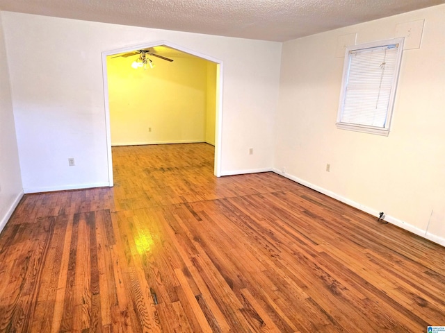 spare room featuring hardwood / wood-style flooring and a textured ceiling