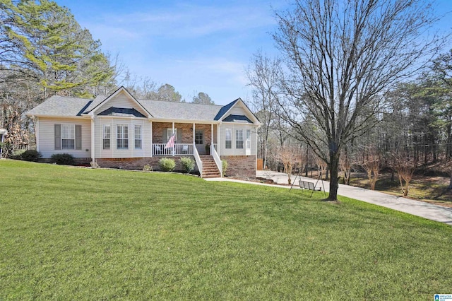 single story home with a front yard and covered porch