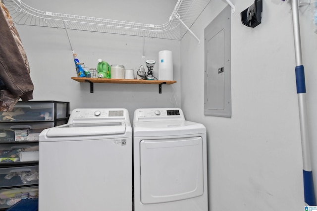 clothes washing area featuring separate washer and dryer and electric panel