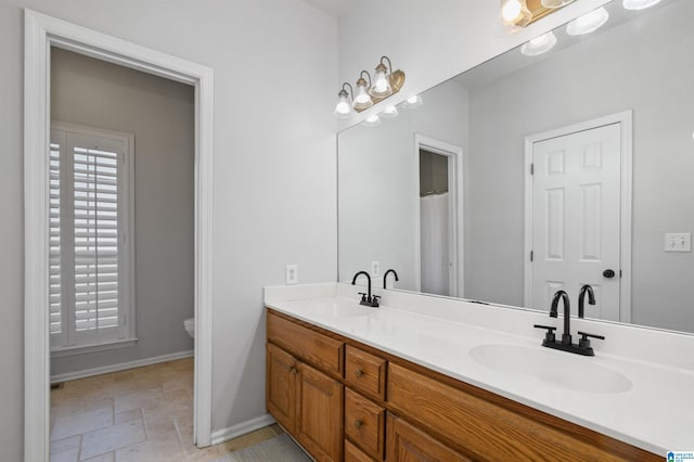 bathroom featuring vanity and toilet