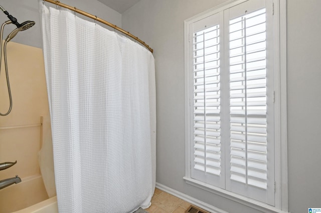 bathroom featuring tile patterned floors and shower / bath combination with curtain