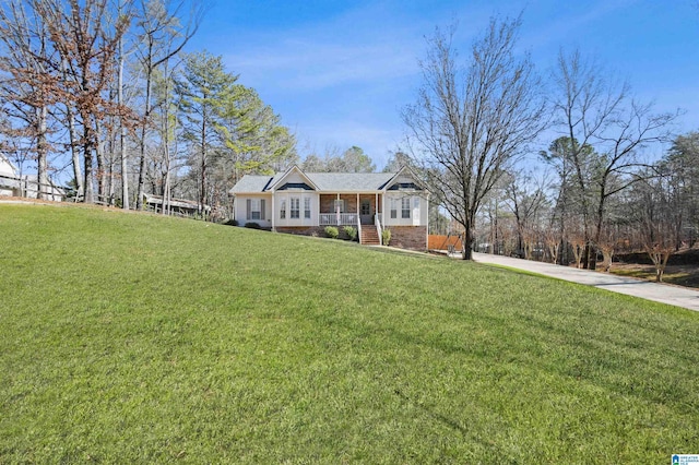 ranch-style house with a porch and a front lawn