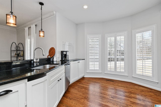 kitchen with dark hardwood / wood-style floors, sink, white cabinets, hanging light fixtures, and stainless steel dishwasher