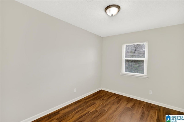 unfurnished room featuring hardwood / wood-style floors and a textured ceiling