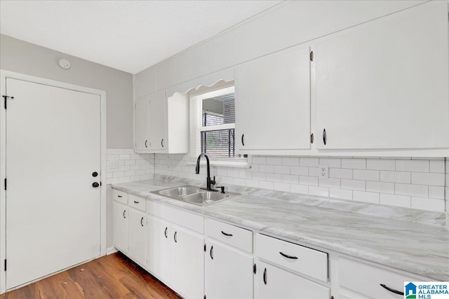 kitchen with white cabinetry and sink