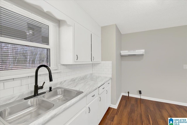 kitchen featuring white cabinetry, dark wood-type flooring, sink, and decorative backsplash