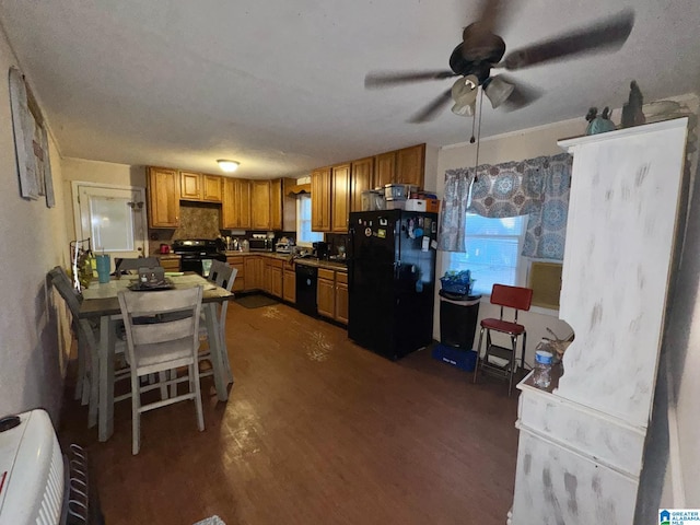 kitchen with black appliances, dark wood-style floors, brown cabinets, and a ceiling fan