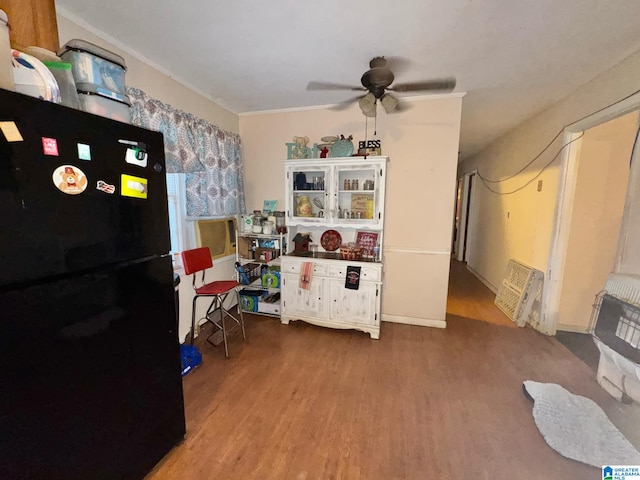 interior space with a ceiling fan and wood finished floors